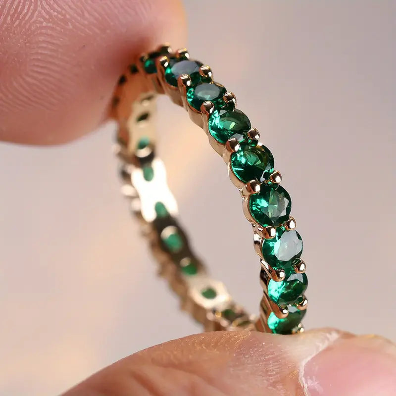 Gold emerald eternity ring