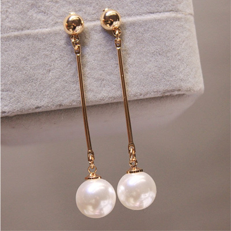Gold long pearl drop earrings