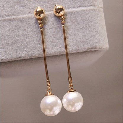 Gold long pearl drop earrings