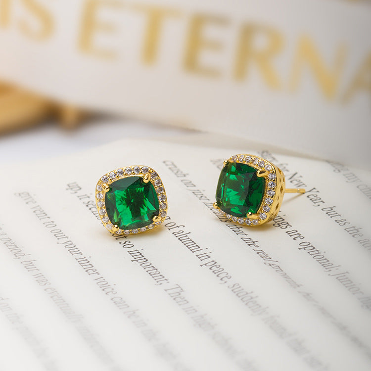 Gold emerald halo stud earrings