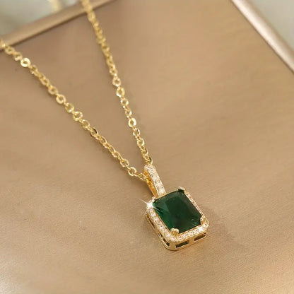 Gold emerald rectangular halo necklace